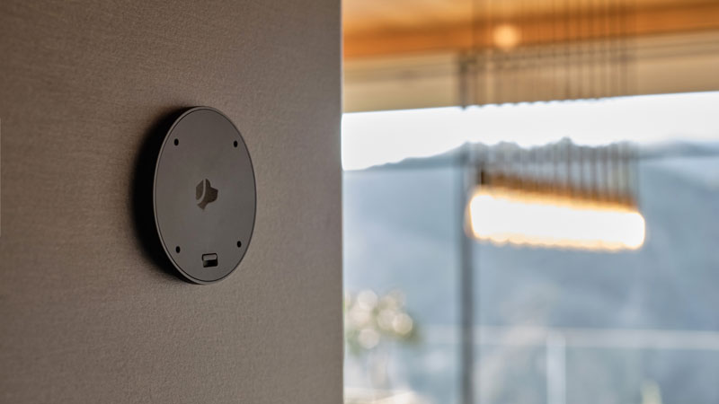 Amazon alexa sitting on table in front of wooden furniture